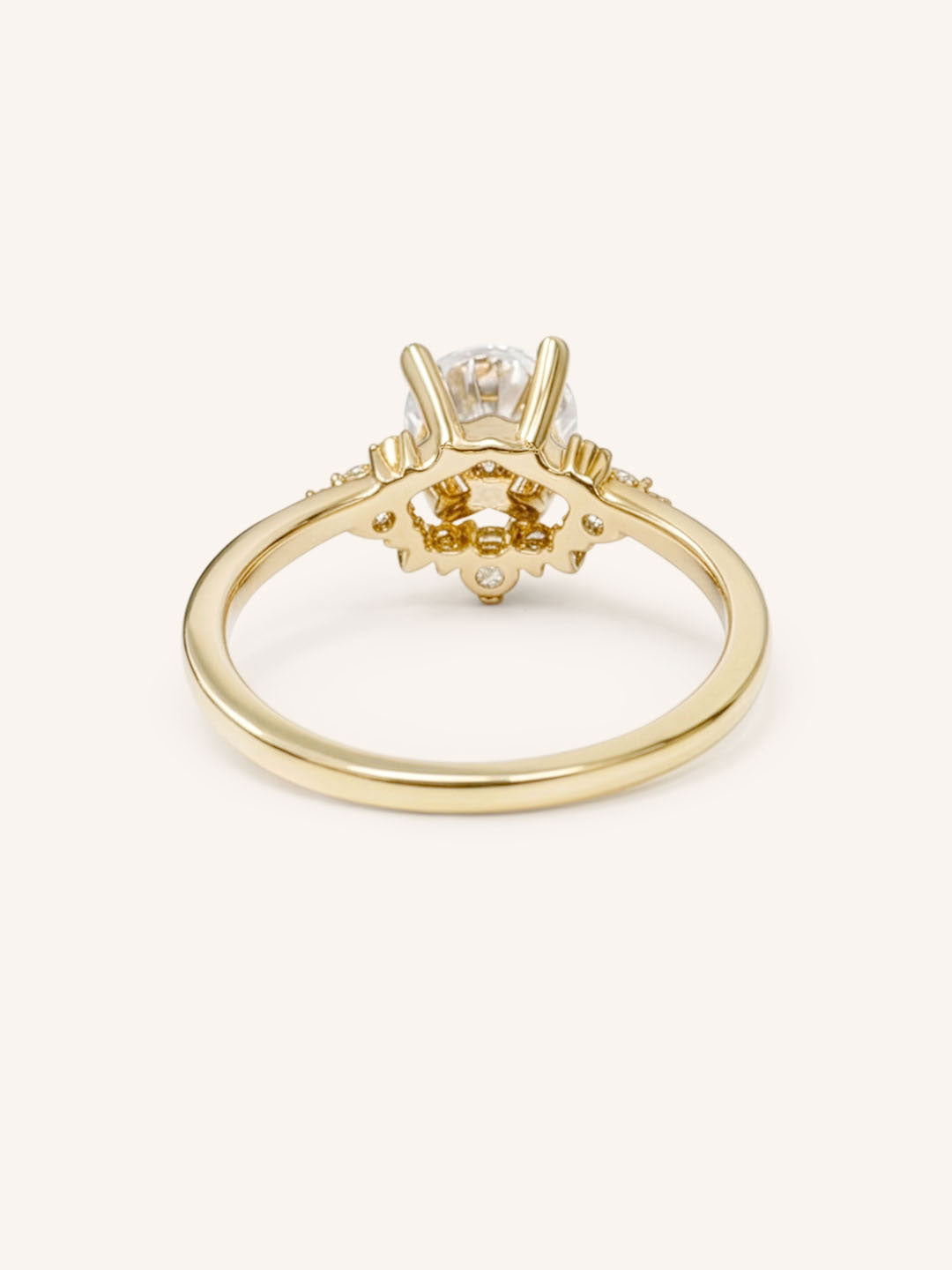 Yellow gold Merilyn round diamond cluster engagement ring back view on white background