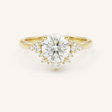 Yellow gold Merilyn round diamond cluster engagement ring front view on white background
