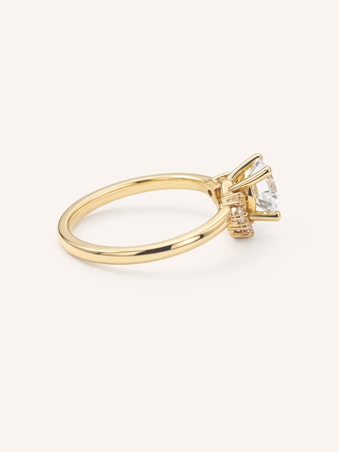Yellow gold Merilyn round diamond cluster engagement ring side view on white background