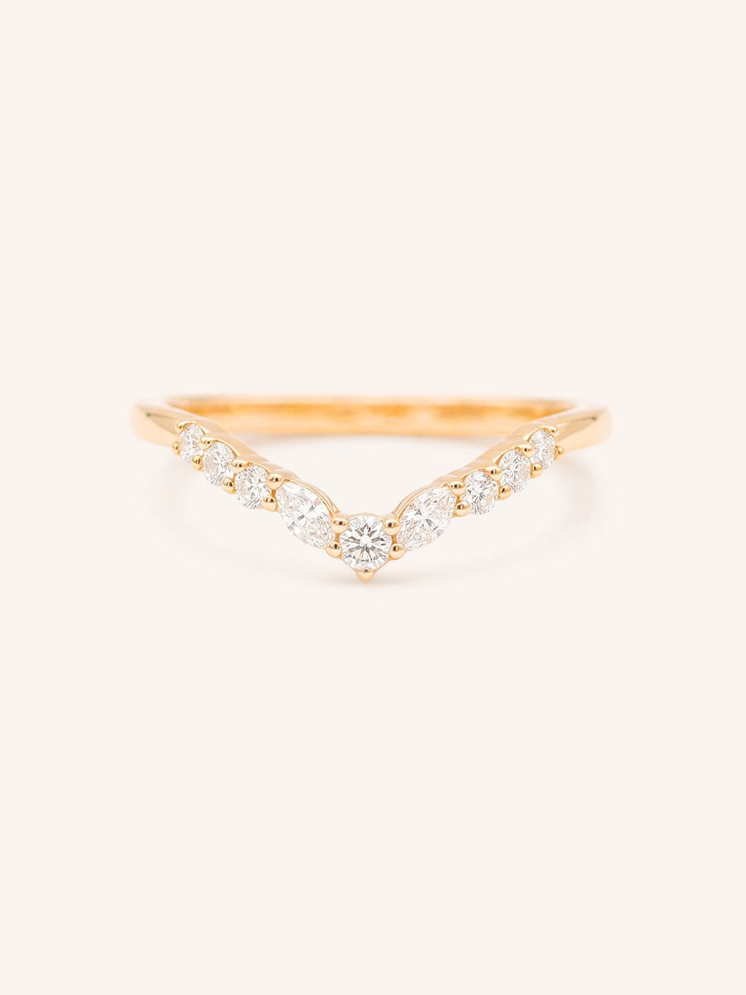 Rose gold ring with diamonds on a white background