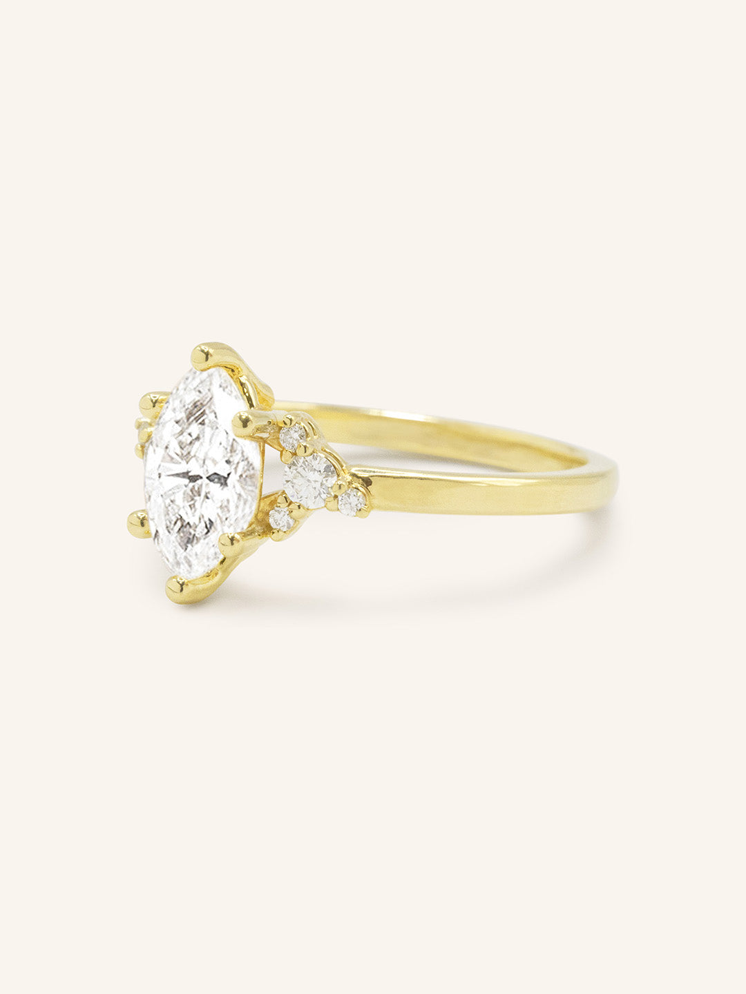 Yellow gold Starfield marquise diamond cluster engagement ring side view on white background