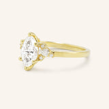 Yellow gold Starfield marquise diamond cluster engagement ring side view on white background