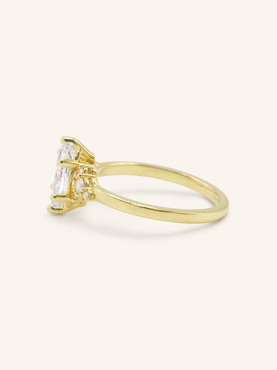Yellow gold Starfield marquise diamond cluster engagement ring side view on white background