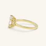 Yellow gold Starfield marquise diamond cluster engagement ring side view on white background