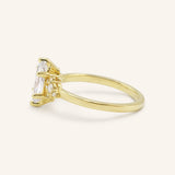 Yellow gold Starfield marquise diamond cluster engagement ring side view on white background