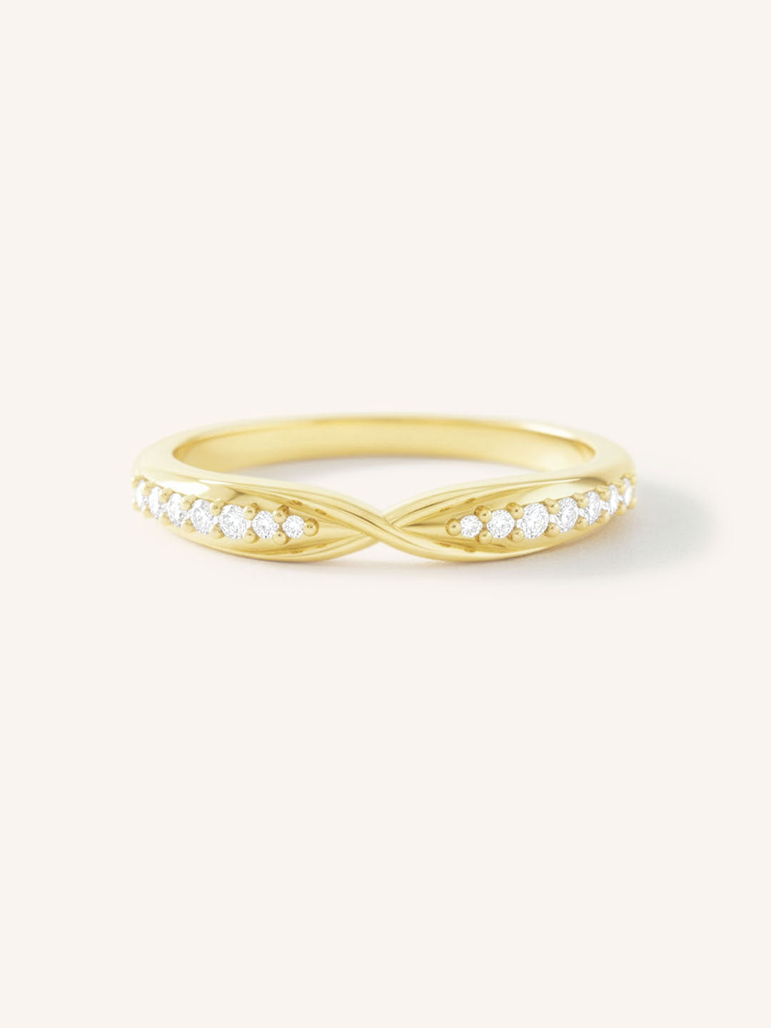 Gold ring with small diamonds on a white background