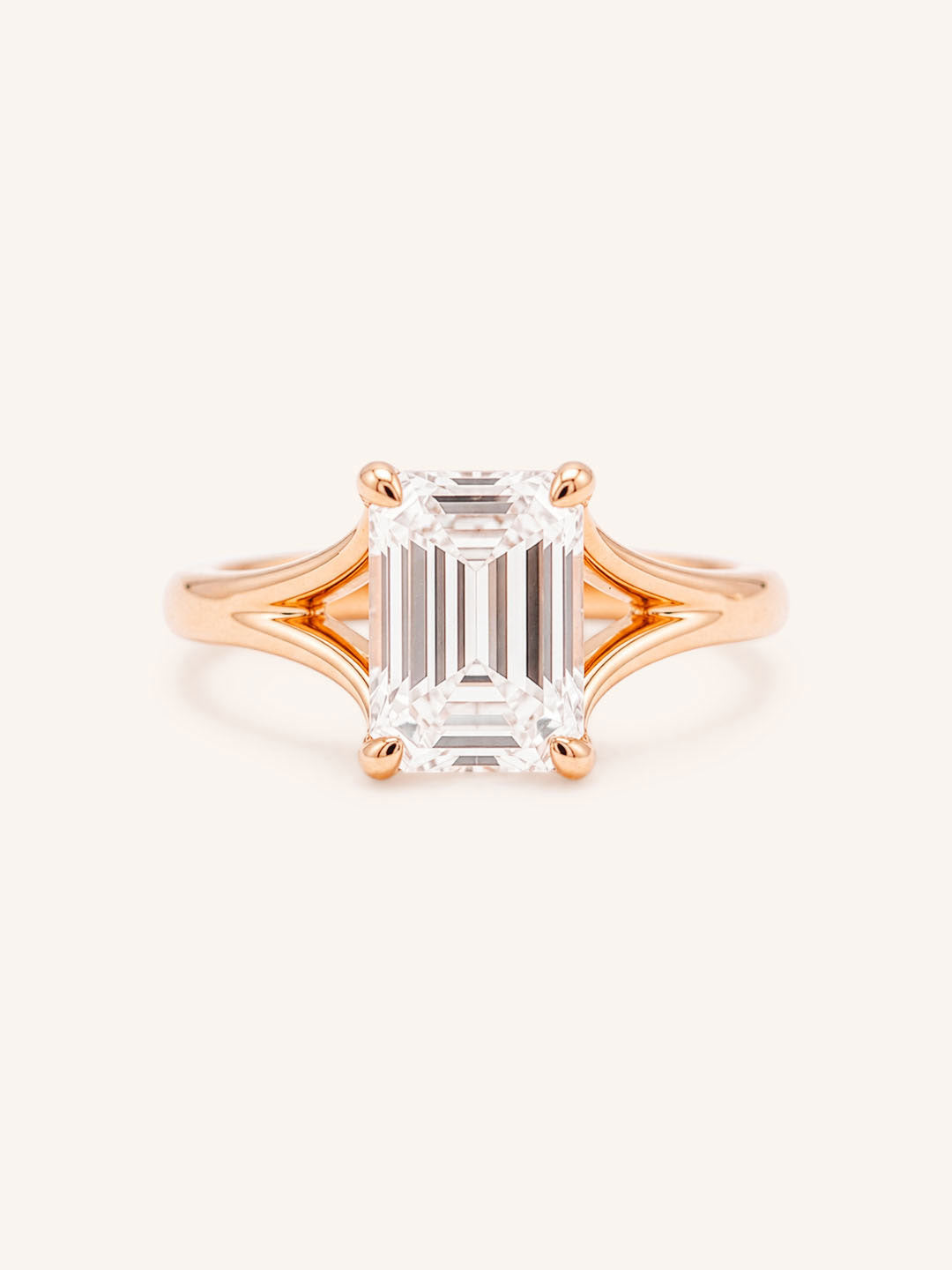 Rose Gold emerald cut diamond split shank engagement ring on white background