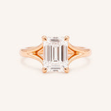 Rose Gold emerald cut diamond split shank engagement ring on white background