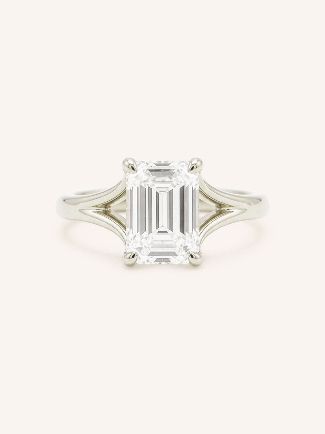 White Gold emerald cut diamond split shank engagement ring on white background