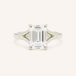 White Gold emerald cut diamond split shank engagement ring on white background
