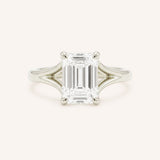 White Gold emerald cut diamond split shank engagement ring on white background
