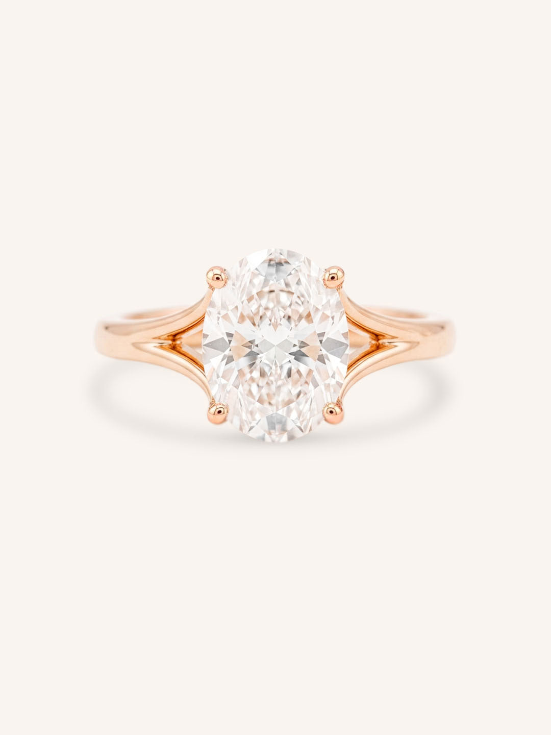 Rose Gold oval diamond split shank engagement ring on white background