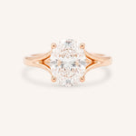 Rose Gold oval diamond split shank engagement ring on white background