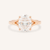 Rose Gold oval diamond split shank engagement ring on white background