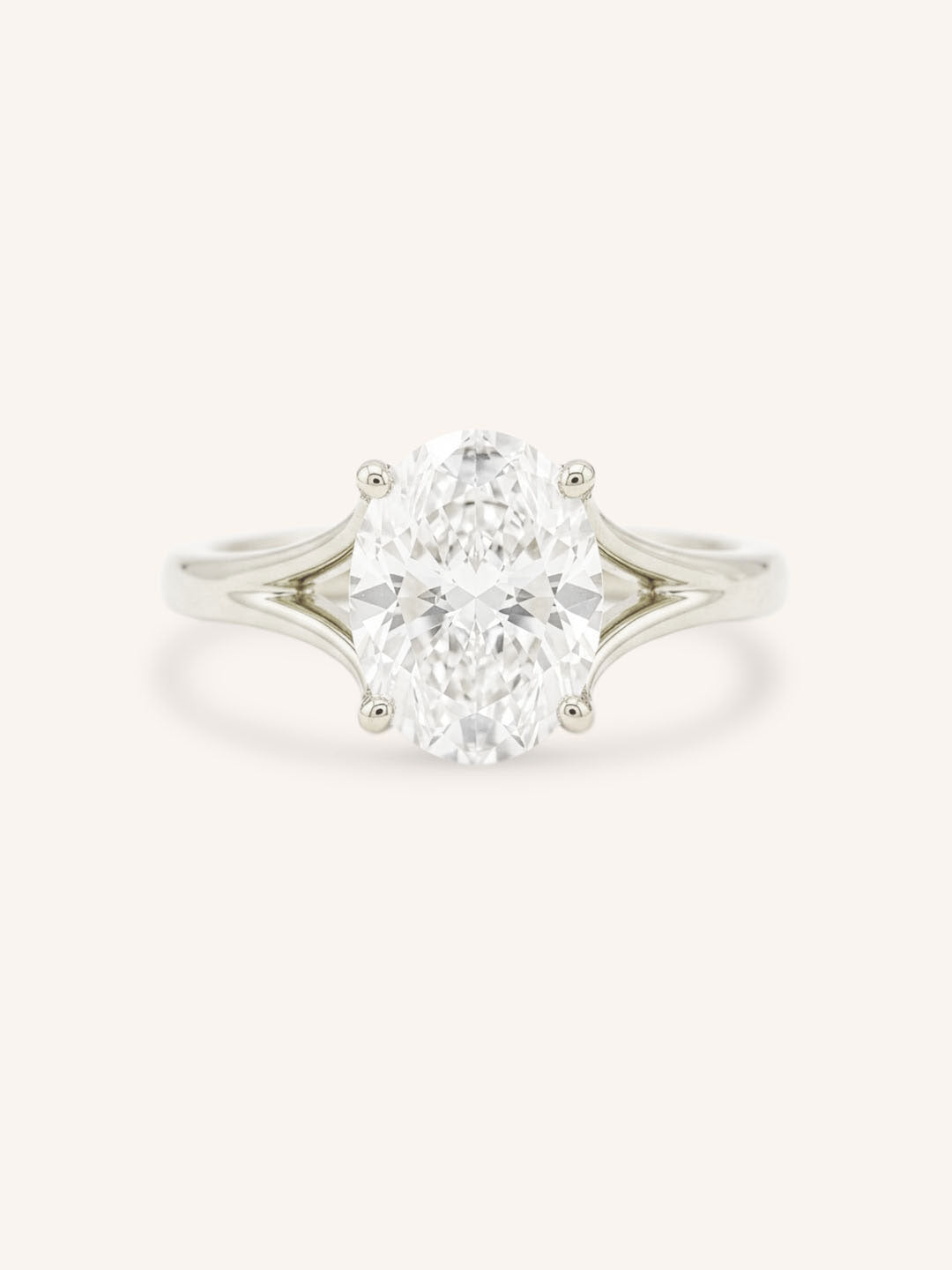 White Gold oval diamond split shank engagement ring on white background