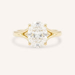 Yellow Gold oval diamond split shank engagement ring on white background