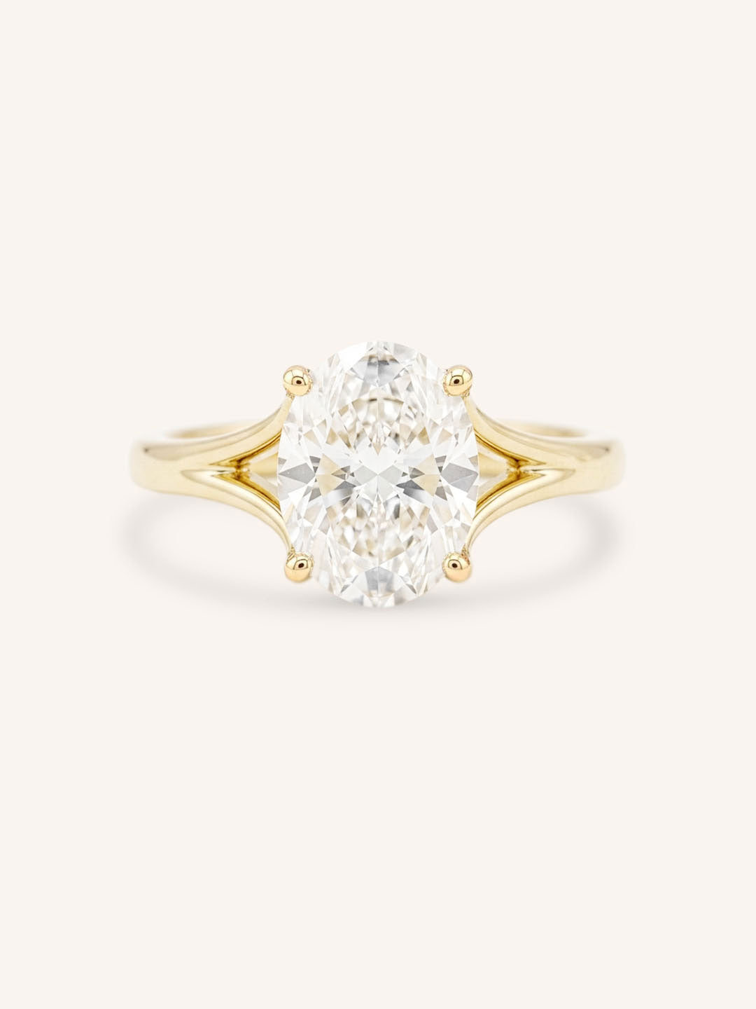 Yellow Gold oval diamond split shank engagement ring on white background