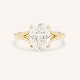 Yellow Gold oval diamond split shank engagement ring on white background
