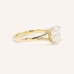 Yellow Gold oval diamond split shank engagement ring side view on white background