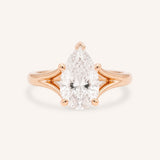 Rose Gold pear cut diamond split shank engagement ring on white background