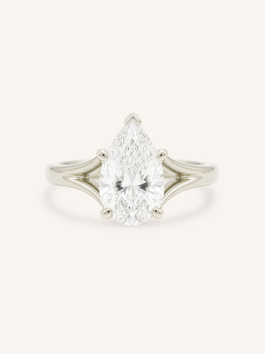 White Gold pear cut diamond split shank engagement ring on white background