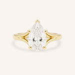 Yellow Gold pear cut diamond split shank engagement ring on white background