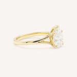 Yellow Gold pear cut diamond split shank engagement ring side view on white background