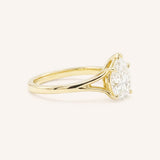 Yellow Gold pear cut diamond split shank engagement ring side view on white background