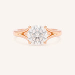 Rose Gold round diamond split shank engagement ring on white background