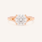 Rose Gold round diamond split shank engagement ring on white background
