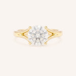 Yellow Gold round diamond split shank engagement ring on white background