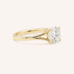 Yellow Gold round diamond split shank engagement ring side view on white background