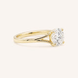 Yellow Gold round diamond split shank engagement ring side view on white background