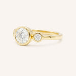 Yellow Gold Tamara Round Three Stone Diamond Bezel Engagement Ring side view on white background