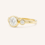 Yellow Gold Tamara Round Three Stone Diamond Bezel Engagement Ring side view on white background