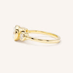 Yellow Gold Tamara Round Three Stone Diamond Bezel Engagement Ring side view on white background
