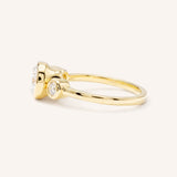 Yellow Gold Tamara Round Three Stone Diamond Bezel Engagement Ring side view on white background