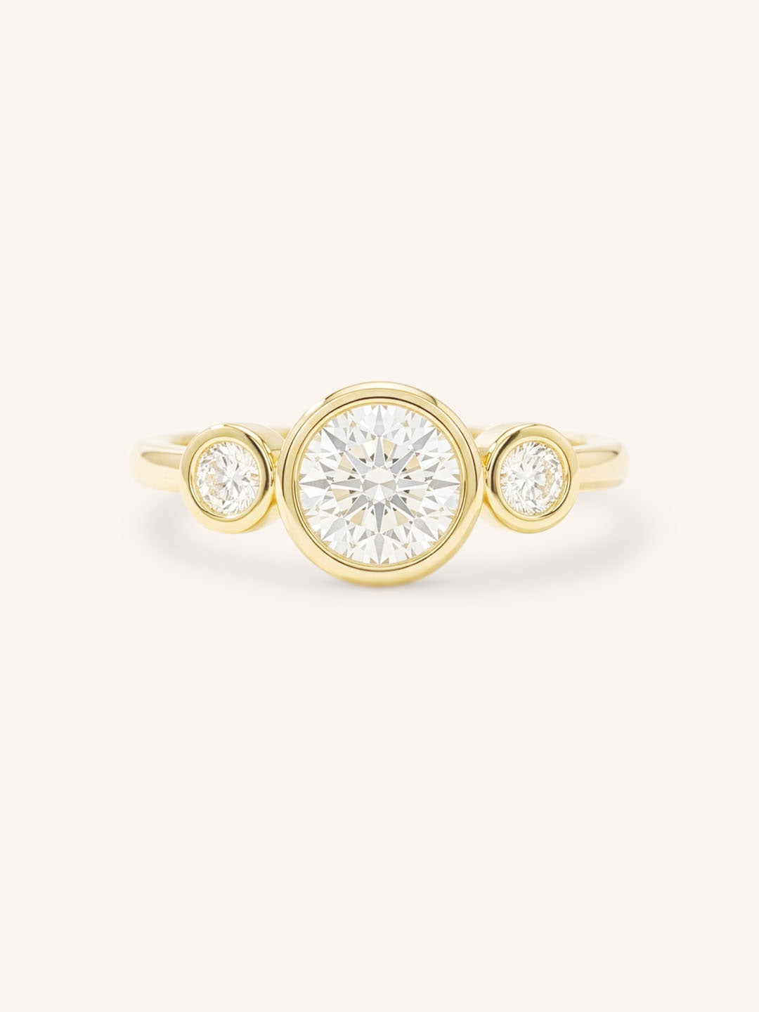 Yellow Gold Tamara Round Three Stone Diamond Bezel Engagement Ring front view on white background