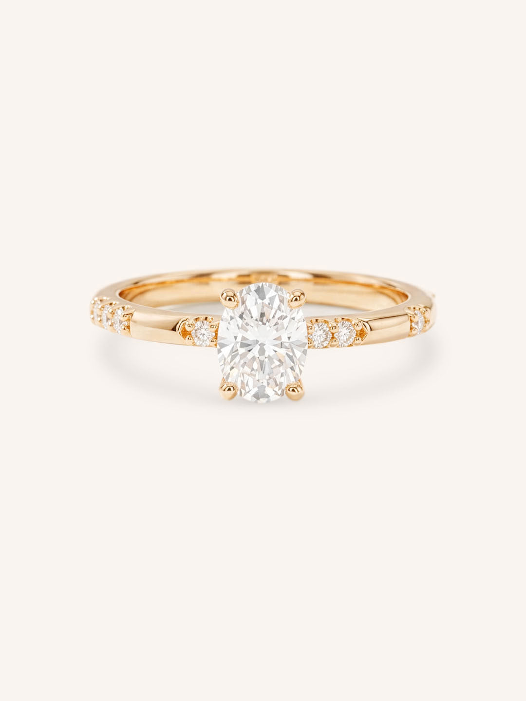 Rose Gold oval diamond engagement ring with accented band on white background
