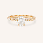 Rose Gold oval diamond engagement ring with accented band on white background