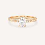 Rose Gold oval diamond engagement ring with accented band on white background
