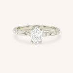 White Gold oval diamond engagement ring with accented band on white background