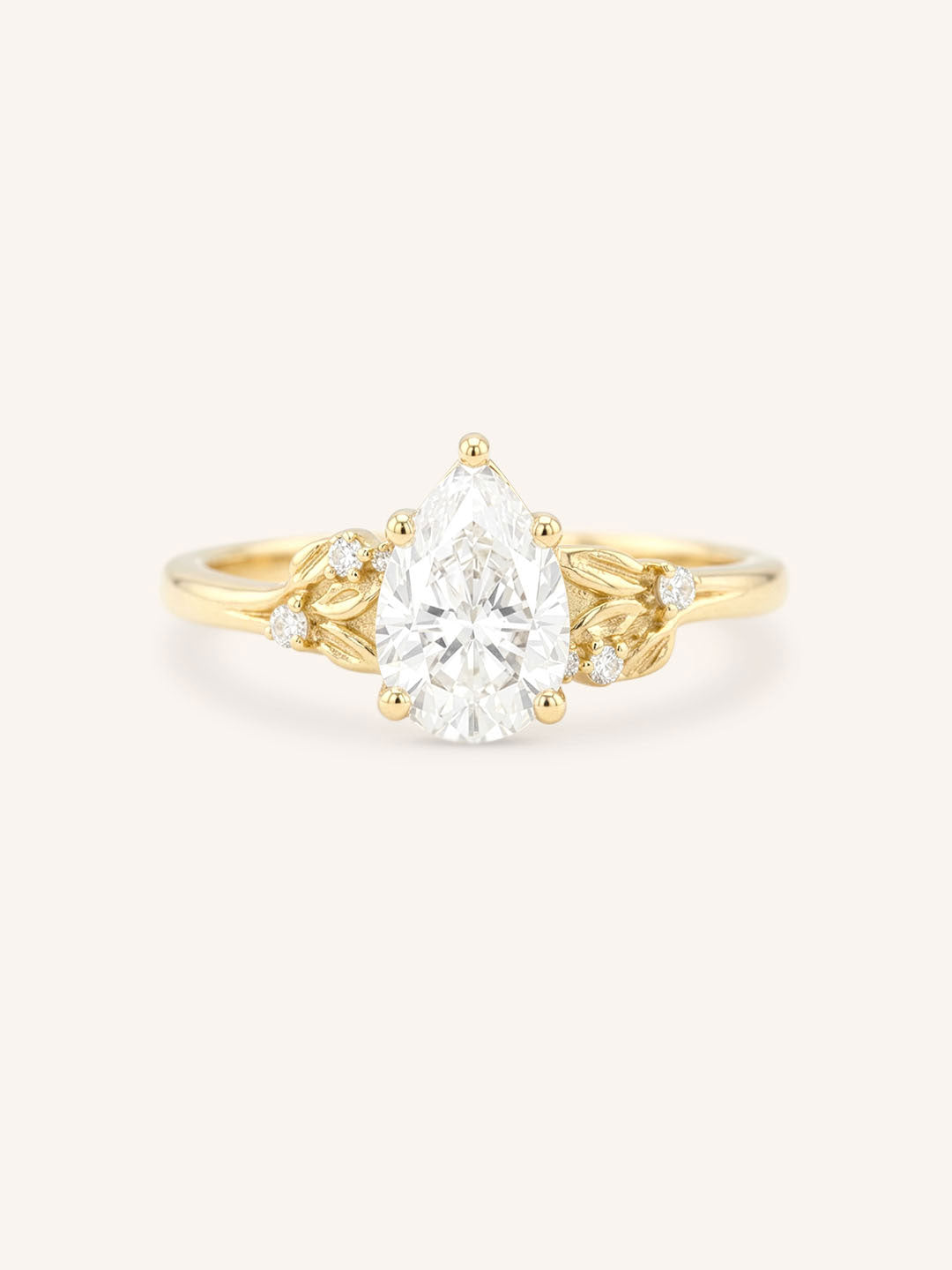 Yellow gold floral pear diamond engagement ring front view on white background