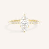 Yellow gold marquise diamond solitaire engagement ring with diamond accents front view on white background
