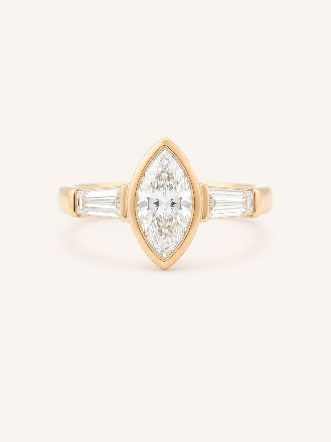 Rose gold Grannis marquise three stone and baguette diamond engagement ring front view on white background