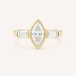 Yellow gold Grannis marquise three stone and baguette diamond engagement ring front view on white background