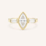 Yellow gold Grannis marquise three stone and baguette diamond engagement ring front view on white background