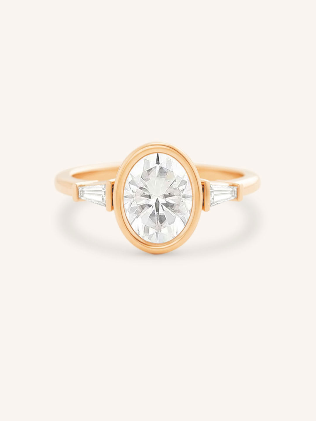 Rose gold Grannis three stone oval and baguette diamond engagement ring front view on white background