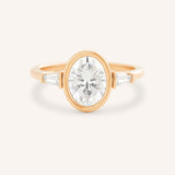 Rose gold Grannis three stone oval and baguette diamond engagement ring front view on white background