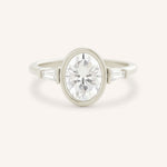White gold Grannis three stone oval and baguette diamond engagement ring front view on white background